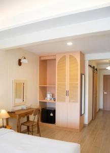 a bedroom with a bed and a table and a desk at An190 Boutique Hotel in Bangkok