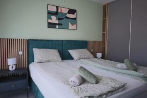 a bedroom with two beds with pillows at Villa Rosa - Luxury Apartments in Vrsi +17 photos