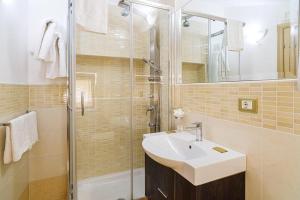 a bathroom with a sink and a shower at Santa Maria Rooms in Santa Maria di Castellabate +14 photos
