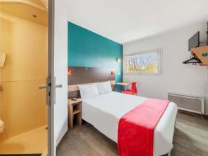 a hotel room with a white bed and a window at hotelF1 Nemours in Nemours