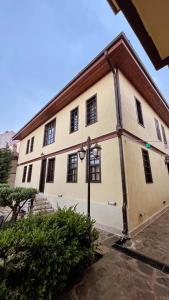 a large white building with a red roof at kuyulu konak in Uşak