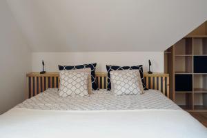 a bedroom with a large bed with pillows at Widokówka in Wetlina