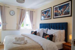 a bedroom with a bed with two towels on it at Luxury 2 Bedroom serviced accommodation in Solihull