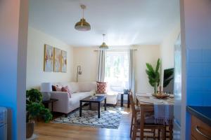 a living room with a couch and a table at Luxury 2 Bedroom serviced accommodation in Solihull