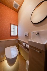 a bathroom with a white toilet and a sink at 金沢町家 凛 in Kanazawa +33 photos