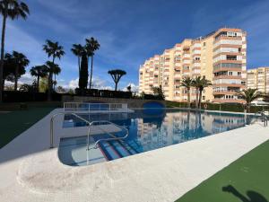 a large swimming pool with a building in the background at Estudio 86 B in Torrox Costa