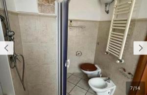 a bathroom with a toilet and a shower with at Casa Annacarla in Noci