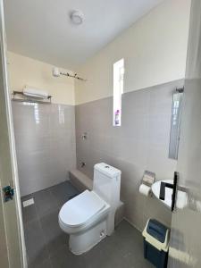 a bathroom with a white toilet and a sink at Sunrise Hills BNB in Ngong