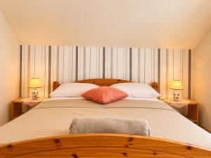 a bedroom with a large bed with two lamps on tables at Apartment House with Shared Pool in Premantura +29 photos