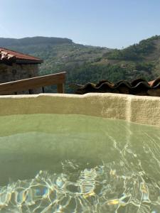 a pool of water with a view of a mountain at Ecolagar O Barqueiro in Pantón