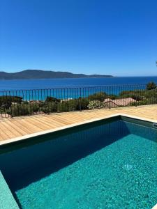 a swimming pool with a view of the ocean at Résidence La Plage in Propriano
