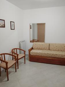 a living room with a couch and two chairs at Casa Amica Termoli 1 in Termoli