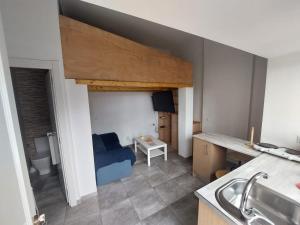 a kitchen with a blue couch in a room at Estudio 86 B in Torrox Costa