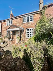 an exterior view of a brick house at Spring Cottage in Hoylake