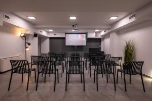 a conference room with chairs and a projection screen at Olympus Jankaea in Paralia Katerinis