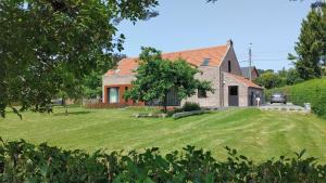 a house with a large yard in front of it at Gîte La Siroperie in Wanze