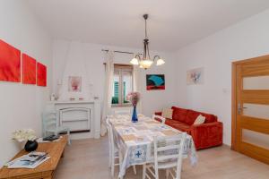 a living room with a table and a red couch at De Addis Guest House in Aggius