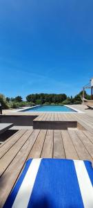 a blue and white rug on a wooden deck at Chambre indépendante vue vignes et mer in Saint-Cyr-sur-Mer