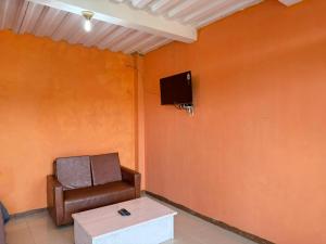 a room with a chair and a tv on a wall at Jayagiri Inn in Tangkubanperahu