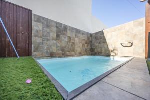 a swimming pool in a backyard with a fence at Casa El Duque Zaira in Vejer de la Frontera