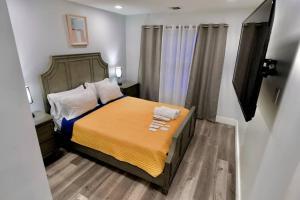 a small bedroom with a bed with two towels on it at The Modern Suite - 2BR Close to NYC in Paterson