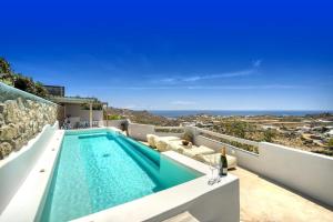 a swimming pool on the balcony of a house at Overview Mykonos Apartments in Mikonos