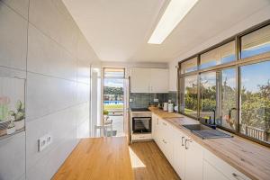 a kitchen with white cabinets and a large window at vv Mirador Al Mar in El Paso
