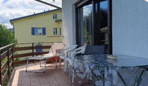 a patio with a table and chairs on a balcony at Villa Franca in Cissano +3 photos