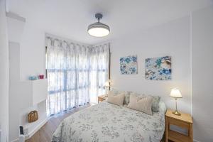 a white bedroom with a bed and a window at vv Mirador Al Mar in El Paso +27 photos