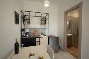 a kitchen and dining room with a table and a sink at Lenaki House in Ayía Kiriakí