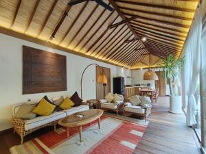 a living room with a couch and a table at BoBos Villa Echo in Canggu