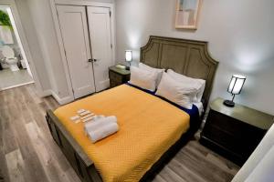 a bedroom with a bed with two towels on it at The Modern Suite - 2BR Close to NYC in Paterson