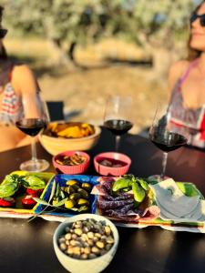 a table with plates of food and glasses of wine at Stella del Rio in Naro