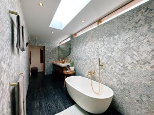 a bathroom with a large tub and a sink at Villa Caz a Bali in Canggu