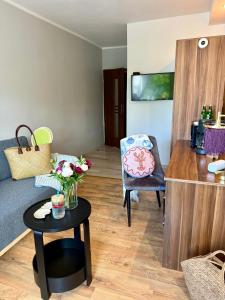 a living room with a couch and a table at Pokoje Gościnne in Kołobrzeg