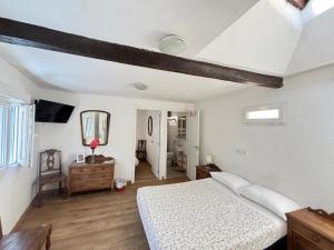 a white bedroom with a bed and a mirror at Pension Alver - El Refugio del Artista in Cudillero +26 photos