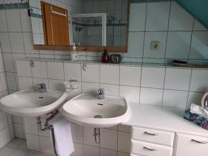 a bathroom with a white sink and a mirror at Ferienwohnung Talblick in Horath +2 photos