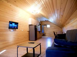 a living room with a couch and a table at Gablile apartments in Mestia