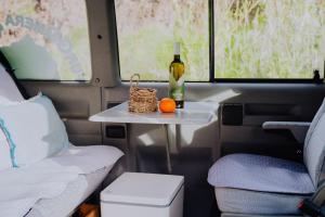 a table with a bottle of wine and an orange on it at Camper Hipalán in San Sebastián de la Gomera