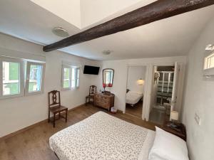 a bedroom with a bed and a tv in it at Pension Alver - El Refugio del Artista in Cudillero