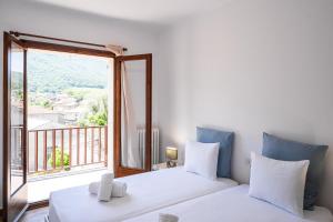 a bedroom with two beds and a large window at Majordoms Art in Sant Feliu de Pallerols +49 photos