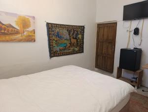 a bedroom with a bed and a painting on the wall at Gılgamesh Maria butik otel in Mardin +32 photos