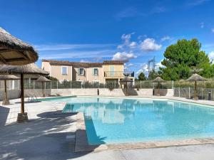 a swimming pool in front of a house at Résidence de la Cabre d'Or in Cabriès