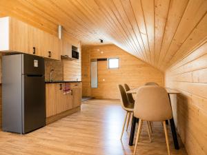 a kitchen with a table and chairs and a refrigerator at Gablile apartments in Mestia