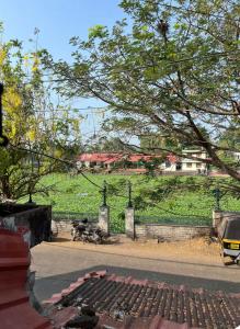 a view of a park with a fence and a field at Heritage Haven in Changanācheri