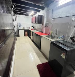 a small kitchen with a sink and a counter at Heritage Haven in Changanācheri