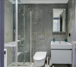 a bathroom with a shower and a toilet and a sink at FOR LARGE FAMILIES, DUPLEX Vılla-304 in Çeşme +13 photos