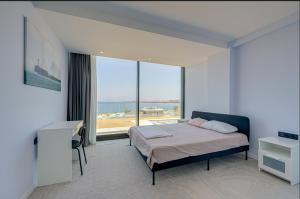 a bedroom with a bed and a large window at FOR LARGE FAMILIES, DUPLEX Vılla-304 in Çeşme