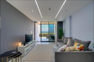 a living room with a couch and a tv at FOR LARGE FAMILIES, DUPLEX Vılla-304 in Çeşme