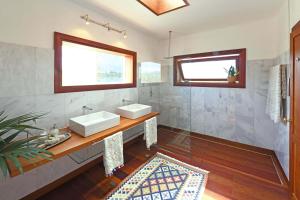 a bathroom with two sinks and a mirror at Casa San Luis in Pájara +16 photos